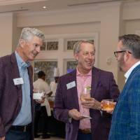 Mike Jandernoa and Jim Teets standing and talking with other event guest